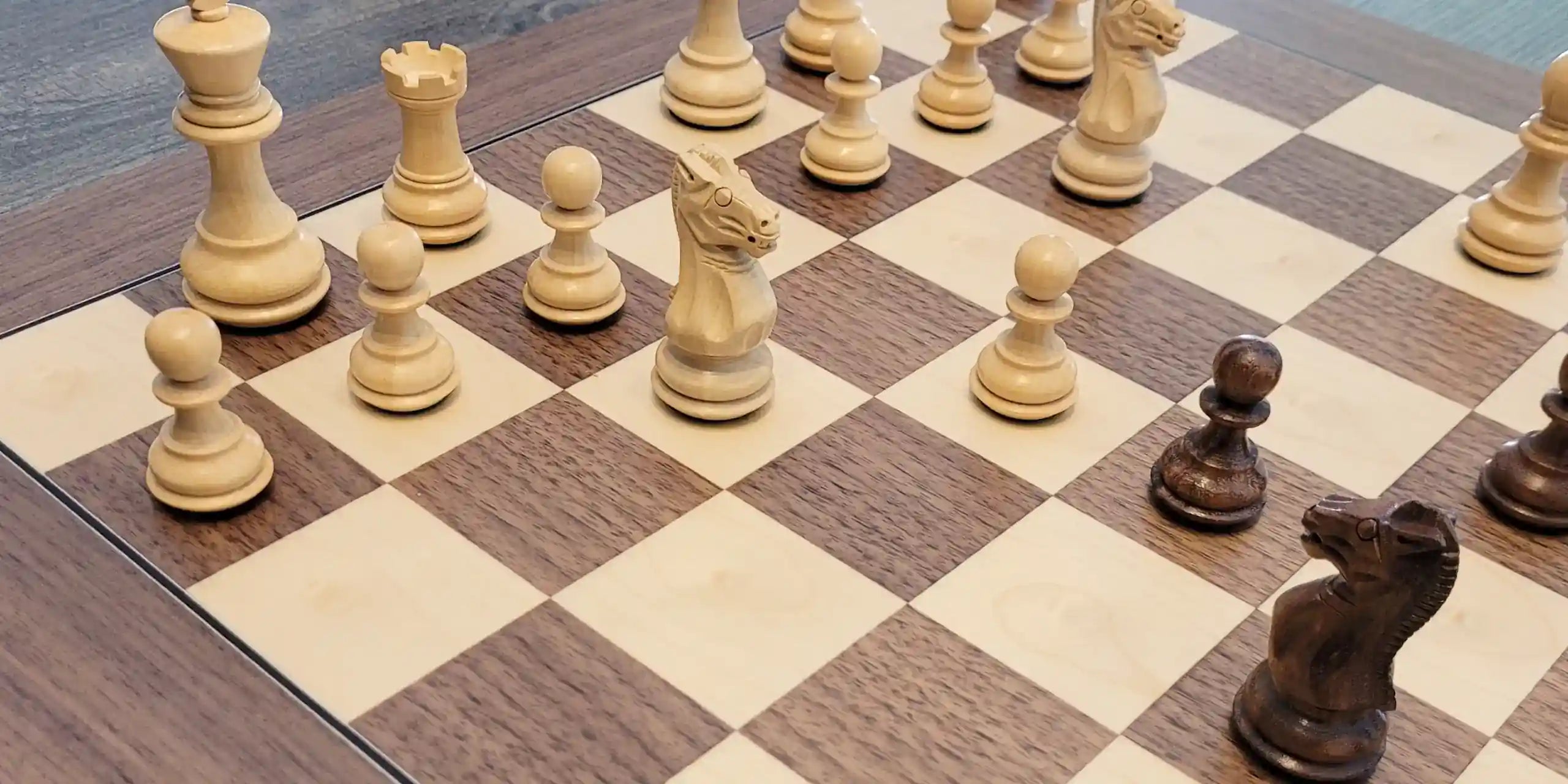 Grace chess pieces on walnut chess board