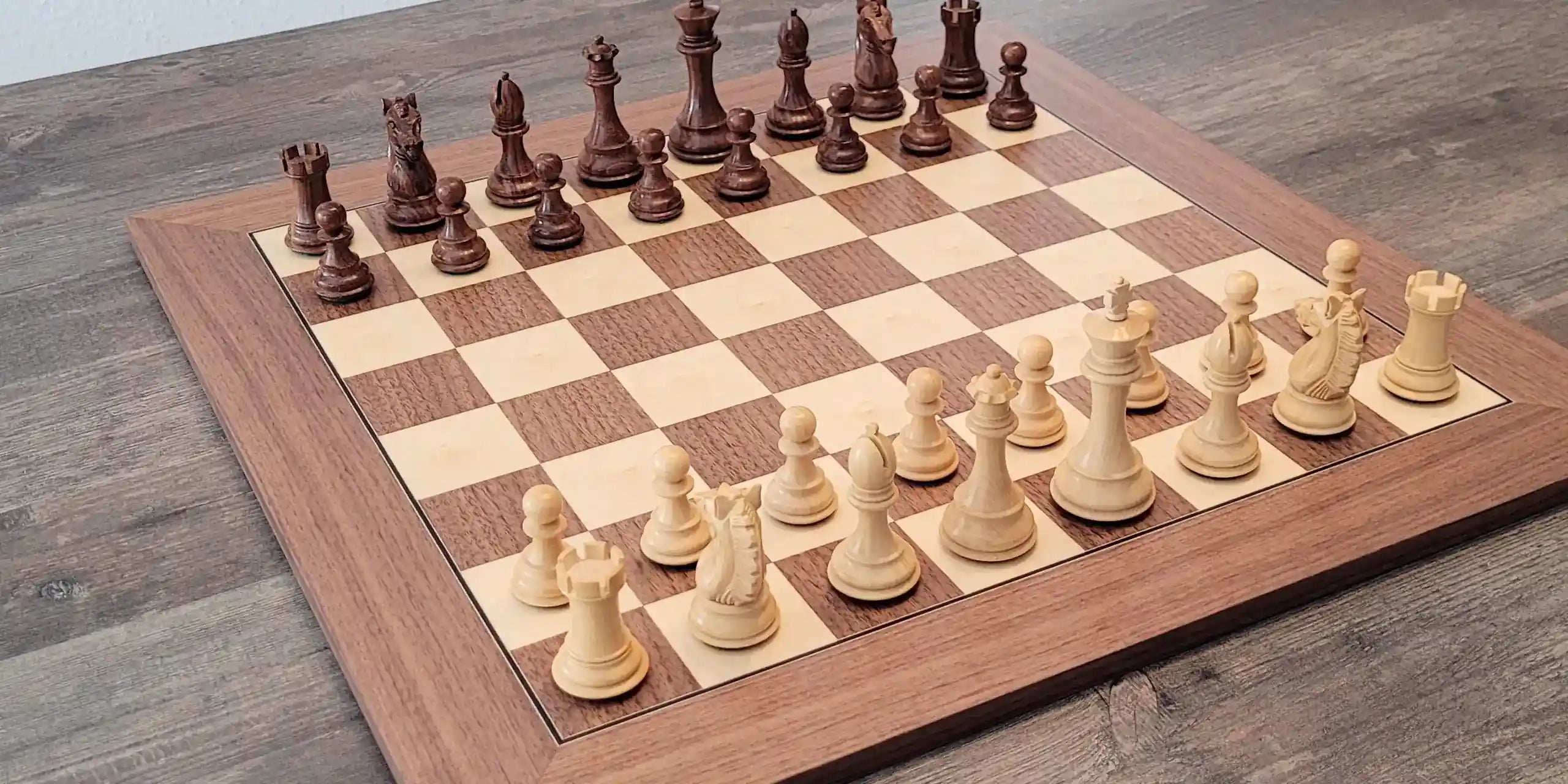 Walnut chess board with Alban Knight palisander chess pieces on it