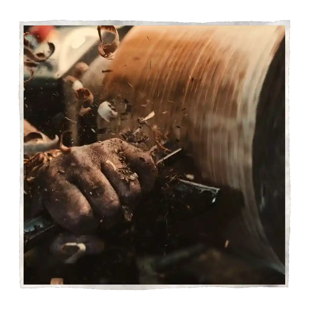 A carver carves wood on the wood lathe